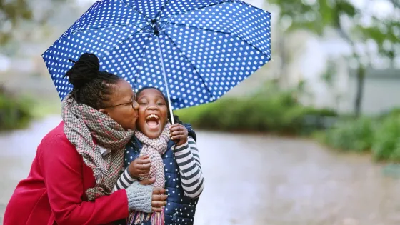 mom and child under an umbrella.