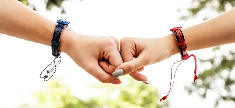 Friends holding hands