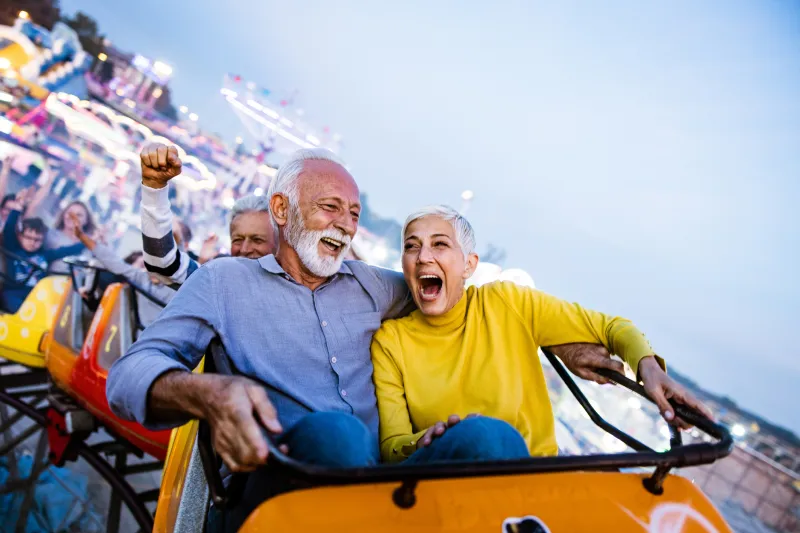 Senior man and woman on a roller coaster