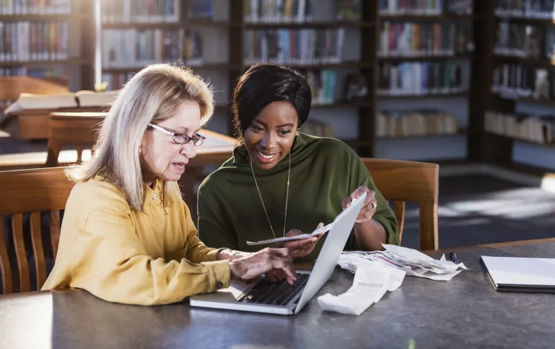 two women working on a computer together