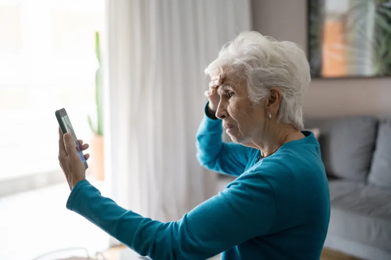 senior woman looking confused at her smart phone