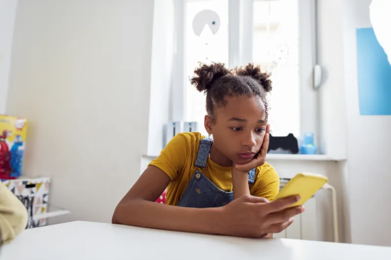 young girl looking at smart phone