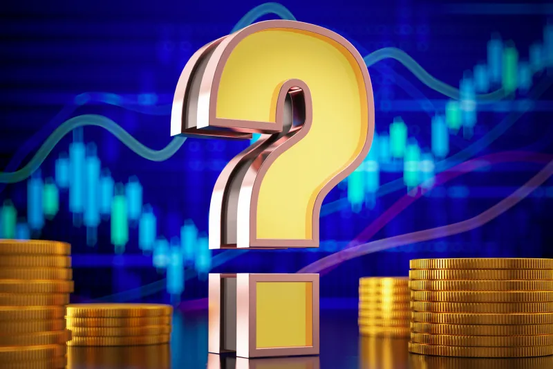 big gold question mark in front of a stock market graph