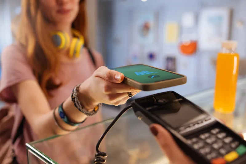 teenager using phone to pay