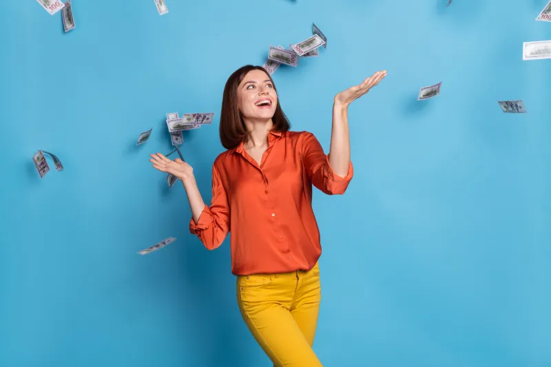 woman standing under falling money