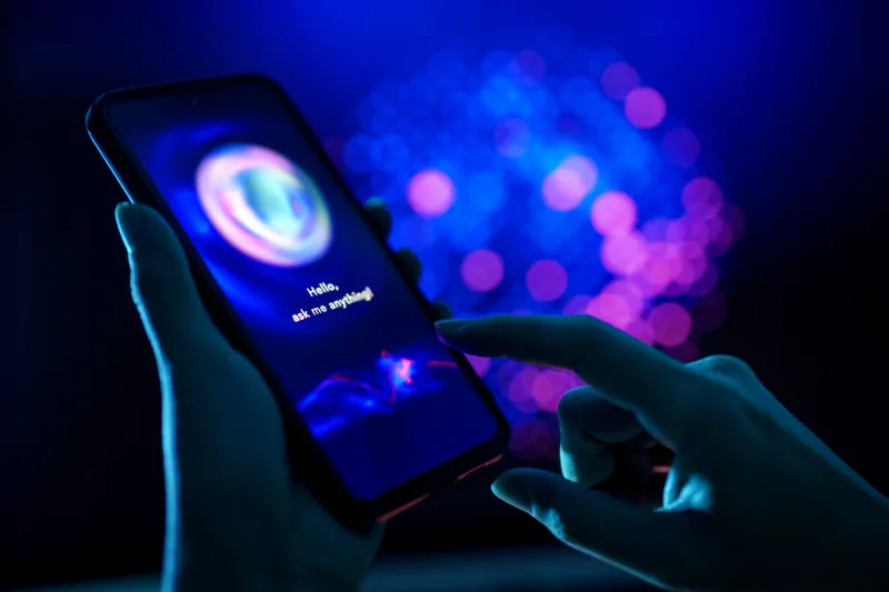 hand holding a dark cell phone