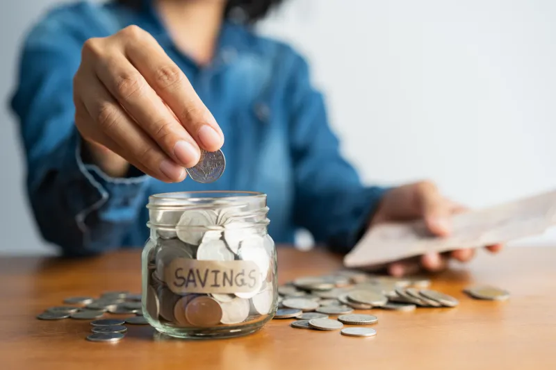 Depositing Coins in Savings Jar