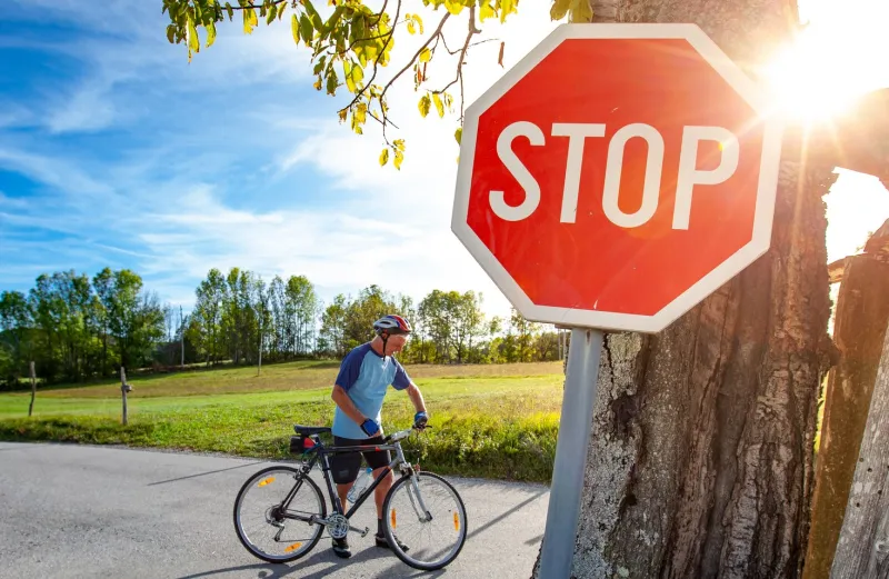 man on a bike at a stop sign