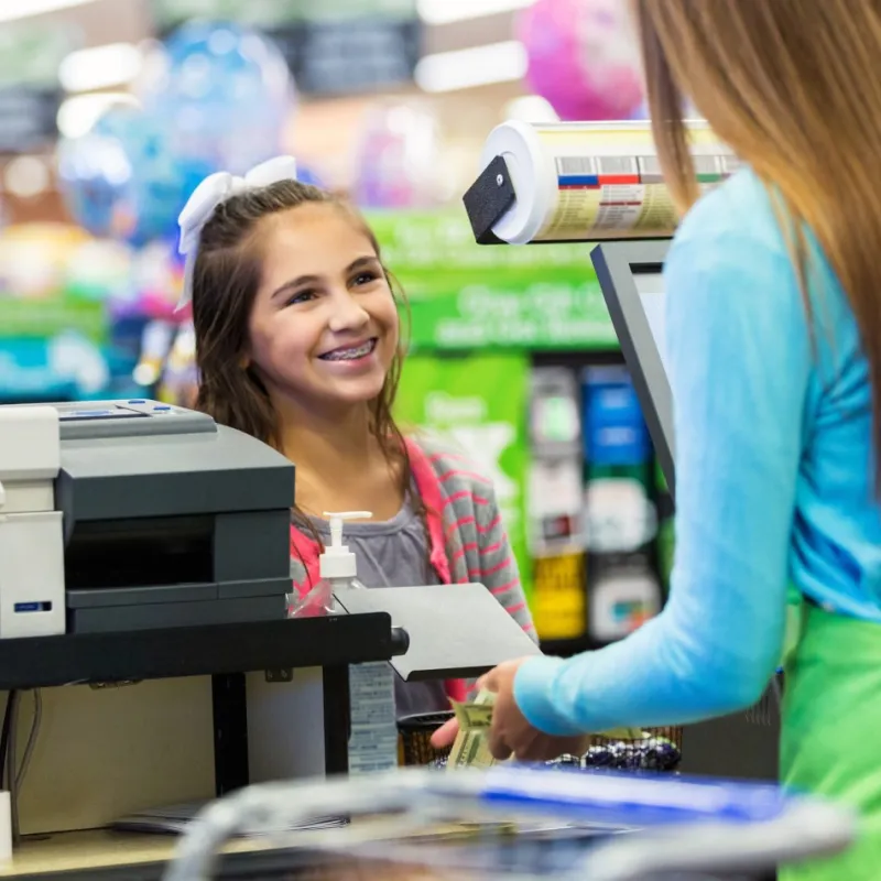 young girl smiling at the check out