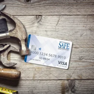 SAFE Credit Card with tools behind it