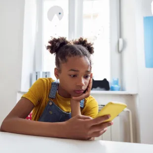 young girl looking at smart phone