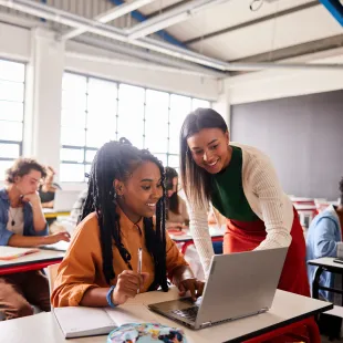 High School Students looking at a laptop