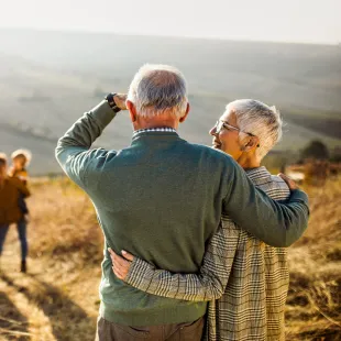 senior couple looking out over their young family.