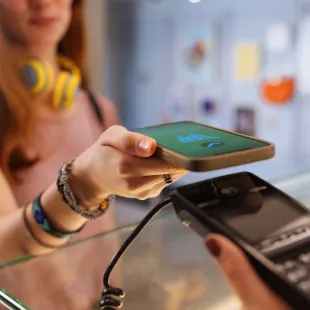 teenager using phone to pay