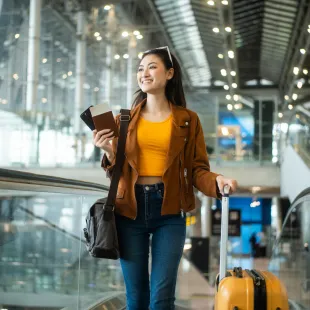 woman walking in a air port with luggage