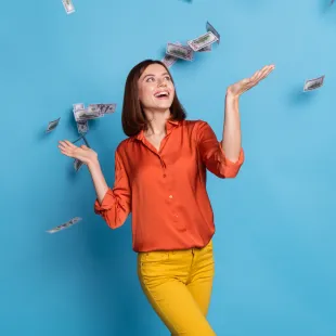 woman standing under falling money