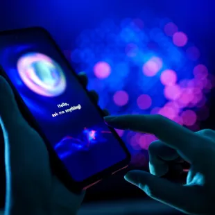 hand holding a dark cell phone