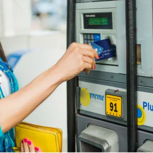 woman using card at the gas pump