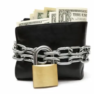 A wallet with a lock and chain around it