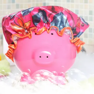 Pink piggy bank wearing a shower cap in a bubble bath