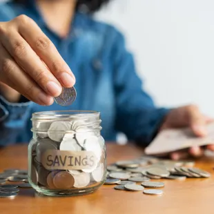 Depositing Coins in Savings Jar
